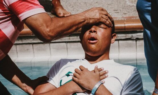 a man doing christian baptism on the water